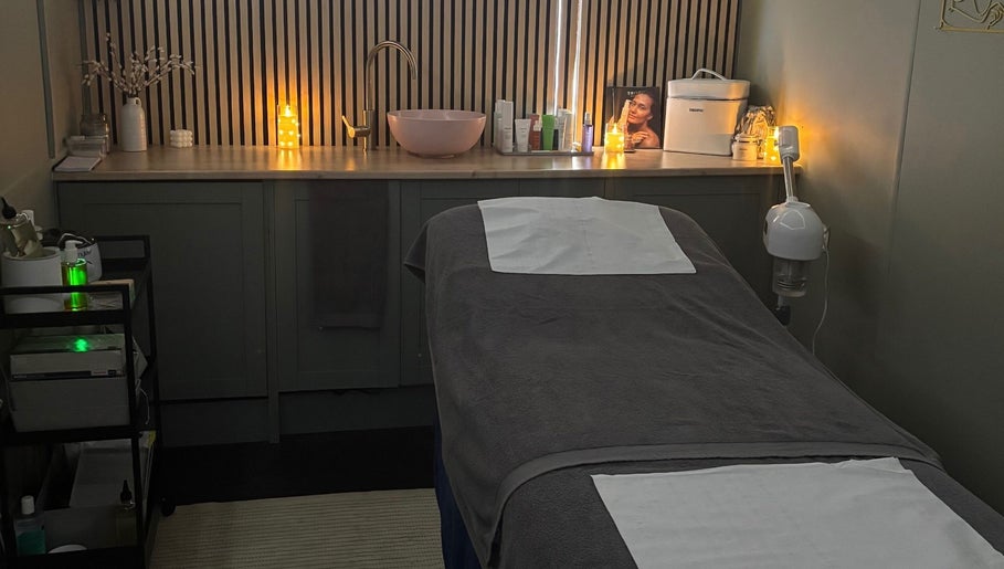 Relaxing treatment room at Bare Beauty Nails, Caerphilly, Cymru, GB, with a comfortable, candle-lit massage bed.