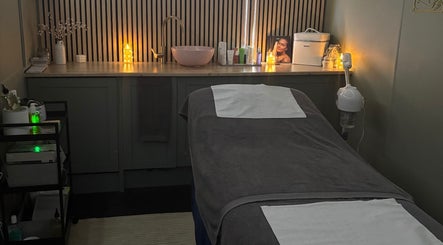 Relaxing treatment room at Bare Beauty Nails, Caerphilly, Cymru, GB, with a comfortable, candle-lit massage bed.