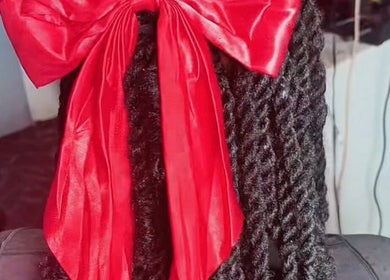 Stylish red ribbon adorns braided hair at Goddess Touch, Georgetown, Demerara-Mahaica, GY.