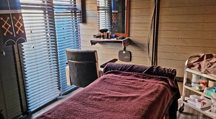 Cozy massage room at Simon's Massage Therapy in Killinghall, England, GB, featuring a peaceful ambiance.