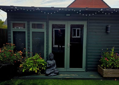 Entrance of Simon's Massage Therapy in Killinghall, England, GB, with serene garden and Buddha statue.