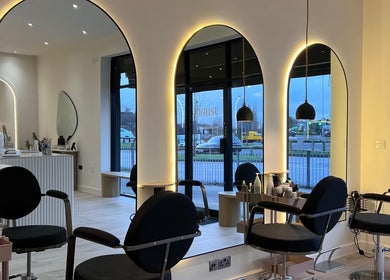 Stylish interior of Chloe Vallance Hairdressing in Northwich, England, GB with modern salon chairs and decor.