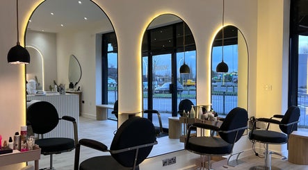 Stylish interior of Chloe Vallance Hairdressing in Northwich, England, GB with modern salon chairs and decor.