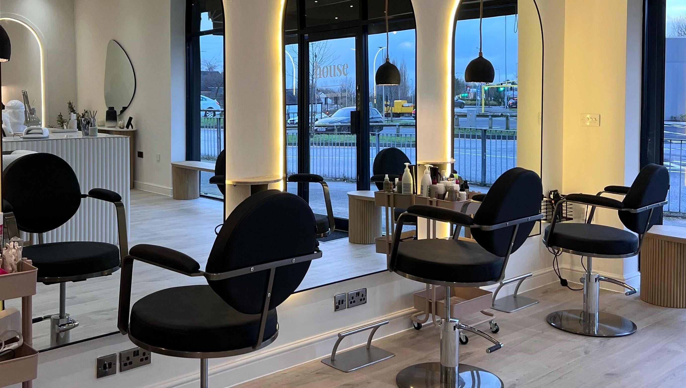 Modern salon interior at Chloe Vallance Hairdressing, Northwich, England, GB with sleek design and styling chairs.