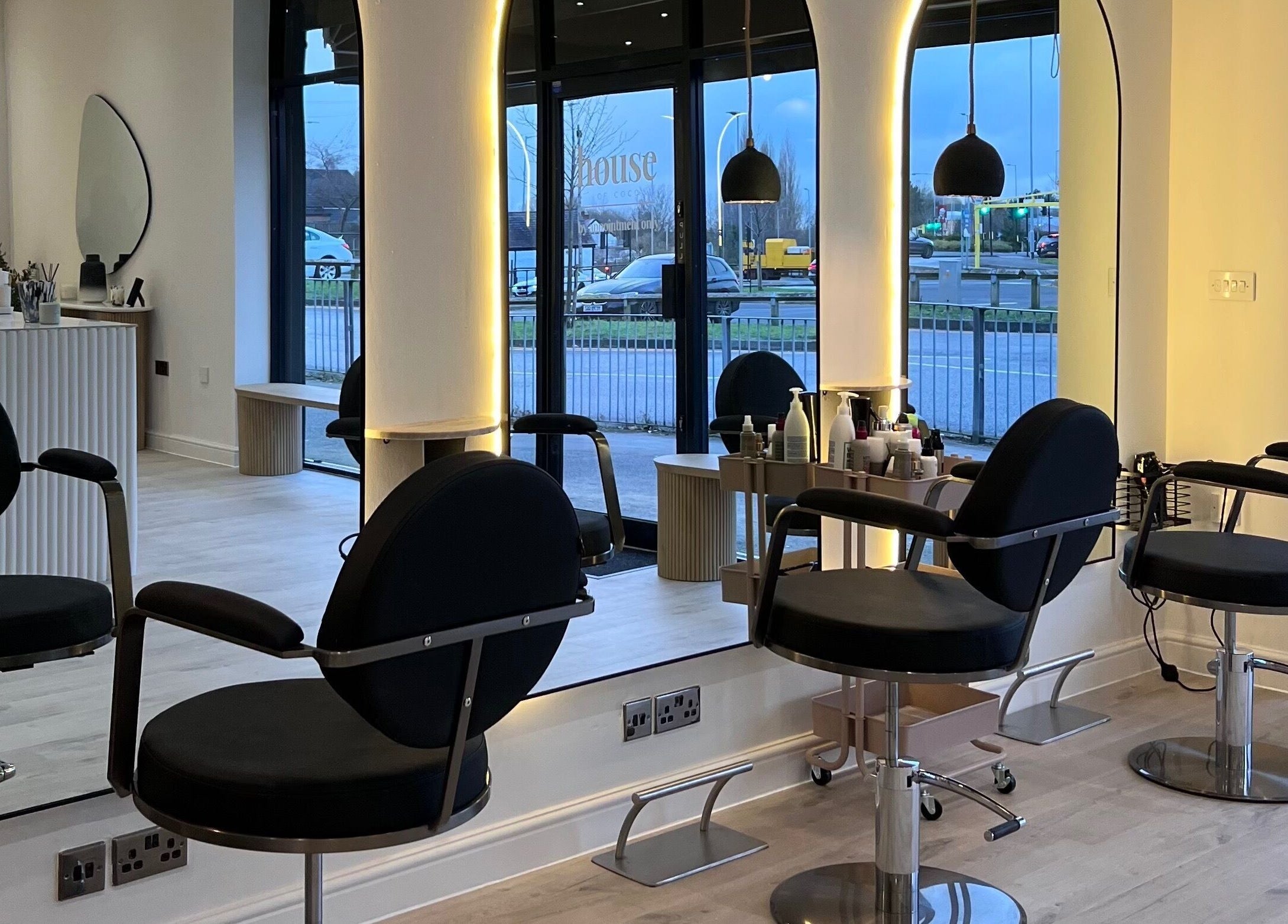 Modern salon interior at Chloe Vallance Hairdressing, Northwich, England, GB with sleek design and styling chairs.