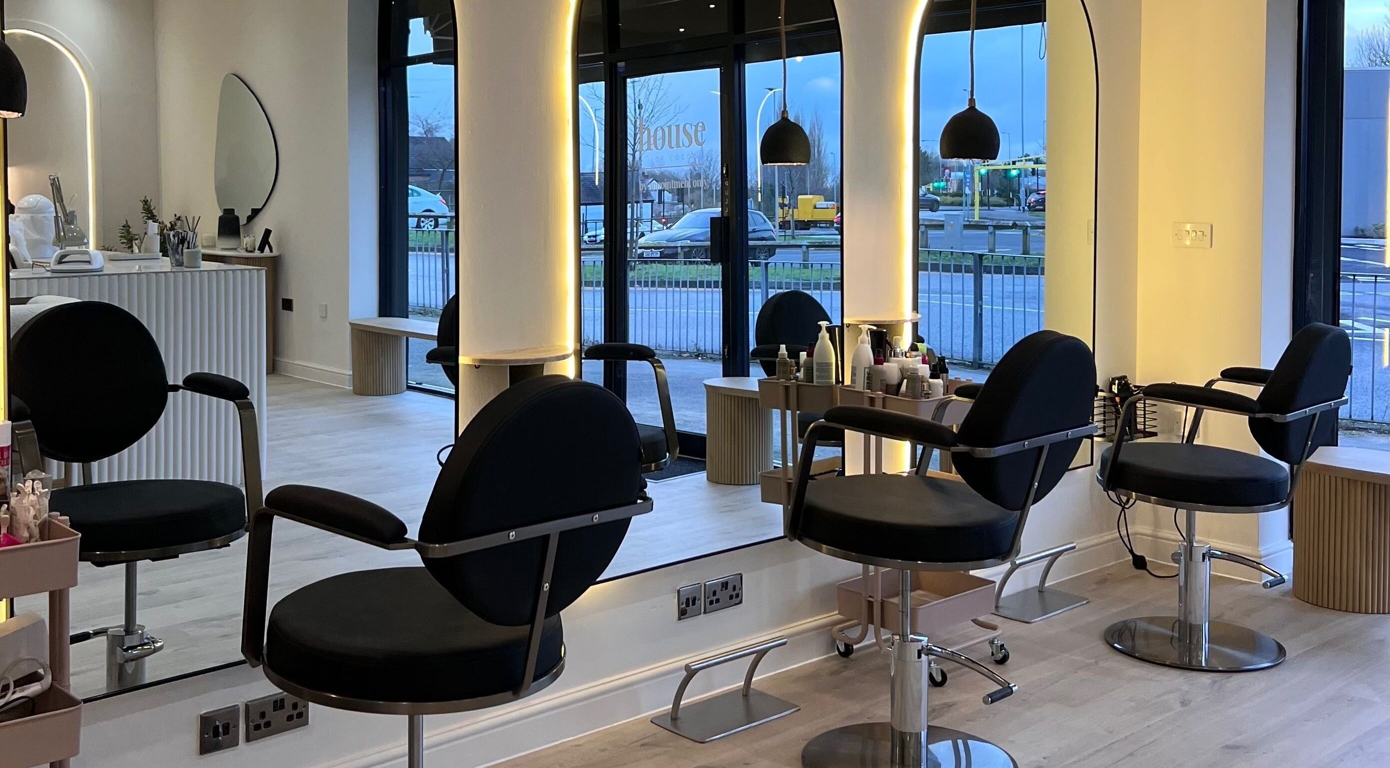 Modern salon interior at Chloe Vallance Hairdressing, Northwich, England, GB with sleek design and styling chairs.