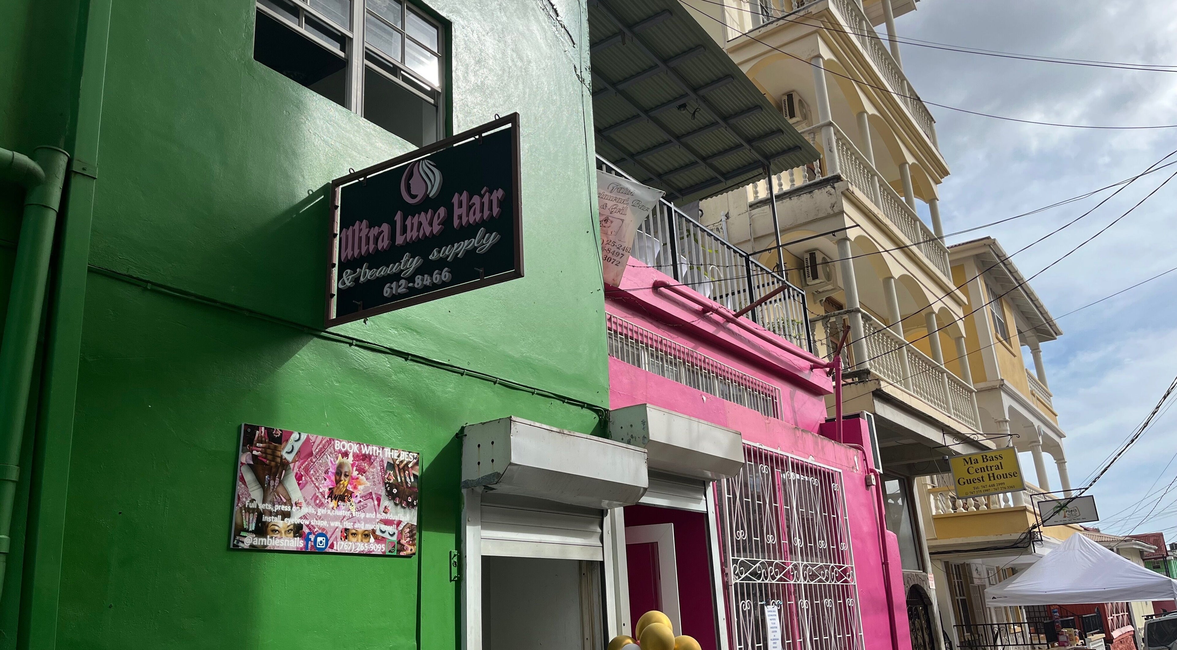 Colorful storefronts near The Beauty Cuisine, Roseau, Saint George Parish, DM.