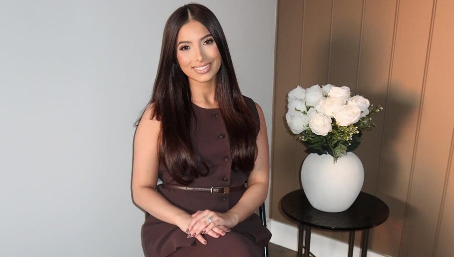 A serene setting at Glow by Jacinda in Gledswood Hills, New South Wales, AU, featuring a woman near elegant decor.