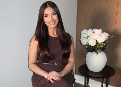 A serene setting at Glow by Jacinda in Gledswood Hills, New South Wales, AU, featuring a woman near elegant decor.