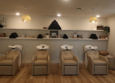 Elegant hair wash stations at Zoetic Beauty in Marion, Illinois, US, featuring modern, plush seating and ambient lighting.