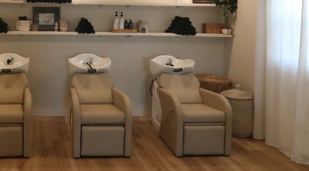 Luxurious wash stations at Zoetic Beauty in Marion, Illinois, US. Inviting and serene for premium salon care.