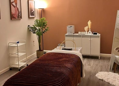 Lashes Forevermore spa room in Hiram, Georgia, US features cozy decor with a massage table and warm lighting.