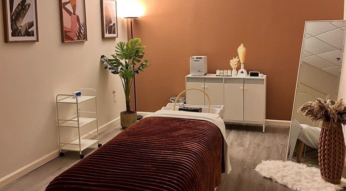 Relaxing therapy room at Lashes Forevermore in Hiram, Georgia, US, featuring a massage table and calming decor.