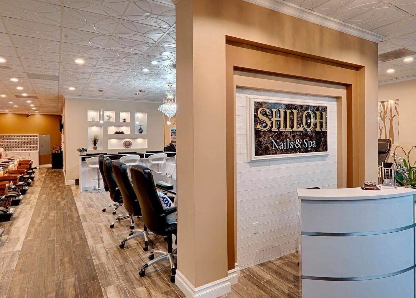 Interior of Shiloh Nails and Spa, Windsor, California, US with stylish chairs and reception desk.