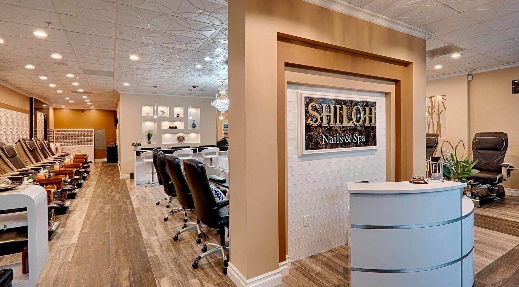 Interior of Shiloh Nails and Spa, Windsor, California, US with stylish chairs and reception desk.
