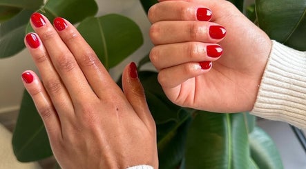 Elegant red manicure at Nailcita_bysim, London, England, GB, showcasing professional nail art.