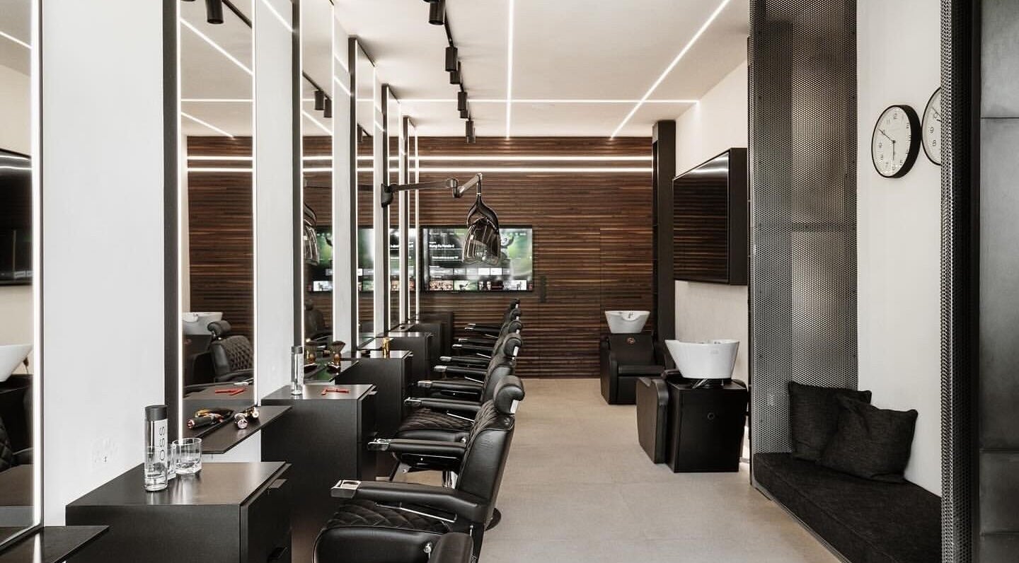 Hdcutz Leo in London, England, GB features sleek modern salon interiors with plush chairs and ambient lighting.