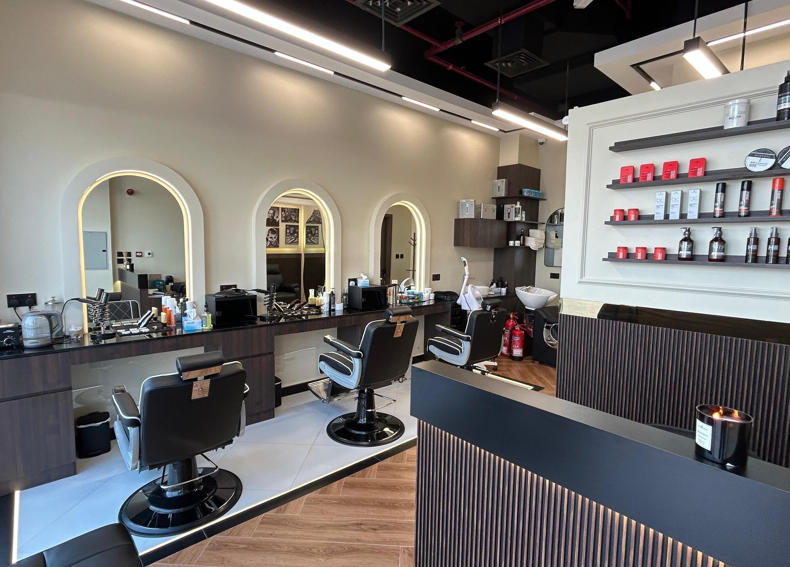 Interior of Zero Double Seven Gents Salon in Dubai, showcasing modern barber chairs and product displays.