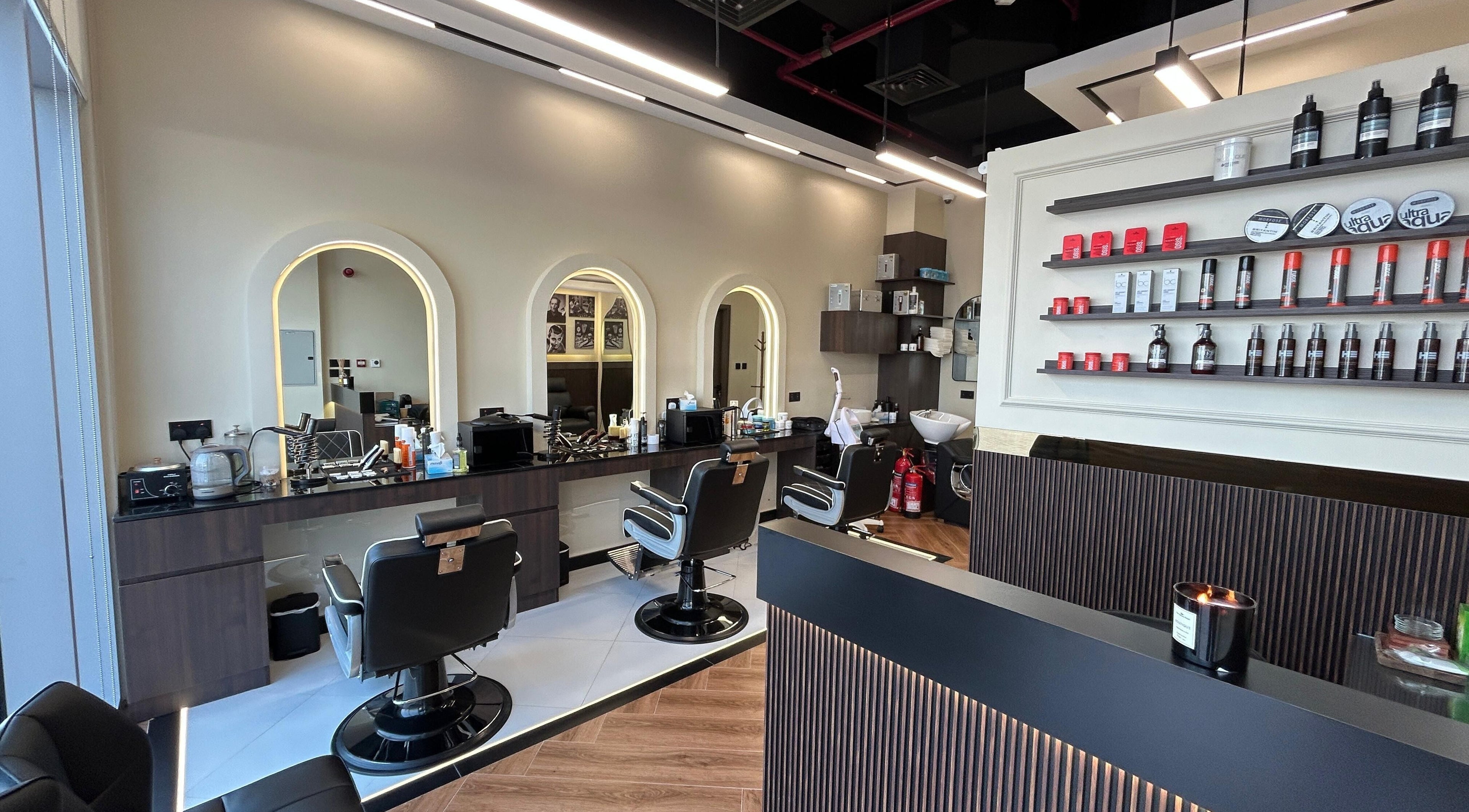 Interior of Zero Double Seven Gents Salon in Dubai, showcasing modern barber chairs and product displays.