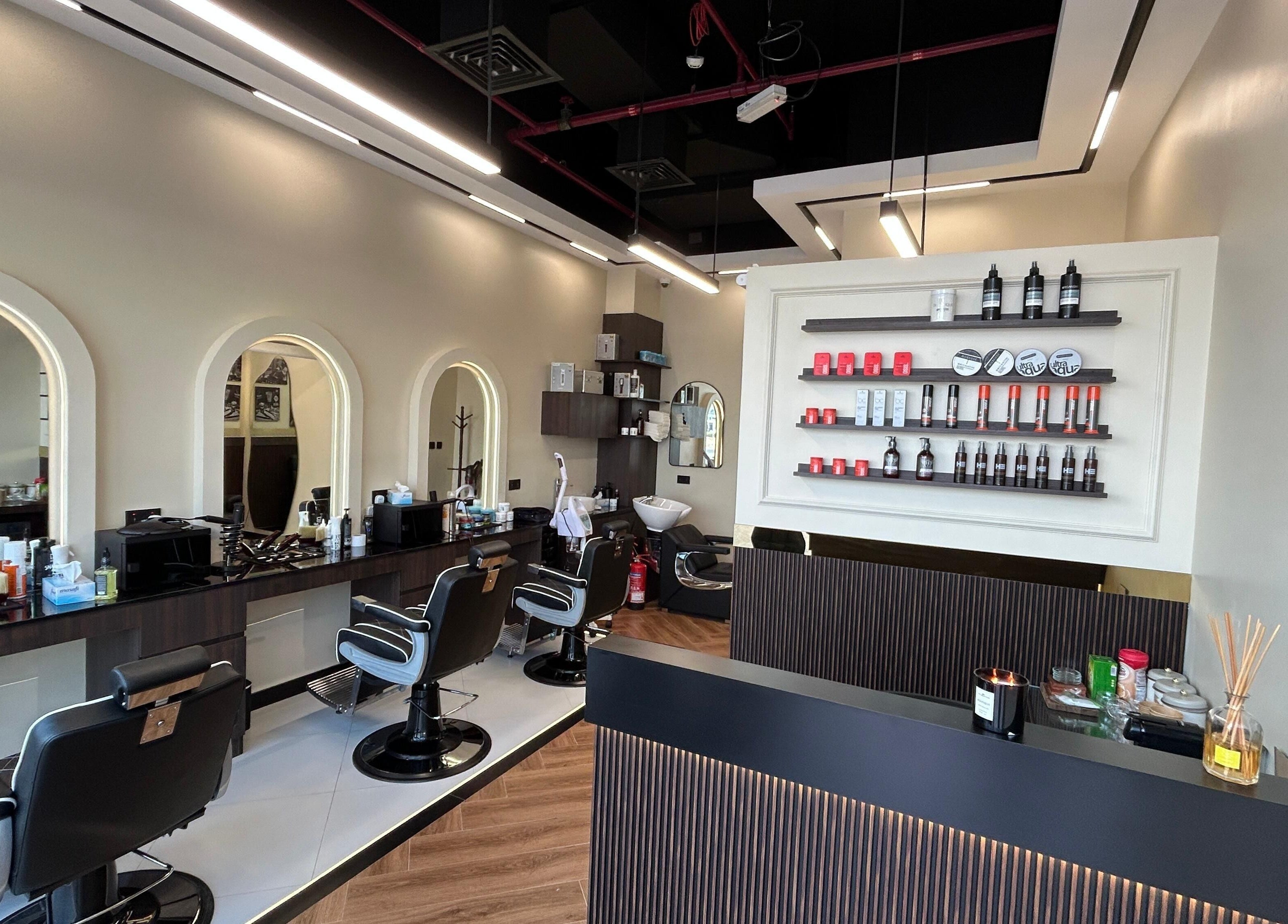 Modern interior of Zero Double Seven Gents Salon, Dubai, Dubai, AE, featuring stylish barber chairs and products.