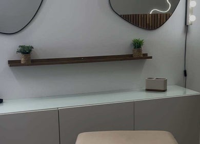 Modern vanity at Emma Pollock Makeup in Clydebank, Scotland, GB with mirrors and greenery decor.