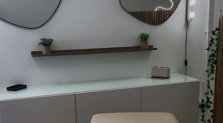 Modern vanity at Emma Pollock Makeup in Clydebank, Scotland, GB with mirrors and greenery decor.