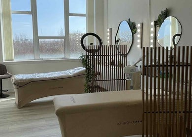 Bright treatment room at Emma Pollock Makeup in Clydebank, Scotland, GB with lash beds and mirrors.