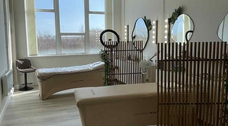 Bright treatment room at Emma Pollock Makeup in Clydebank, Scotland, GB with lash beds and mirrors.