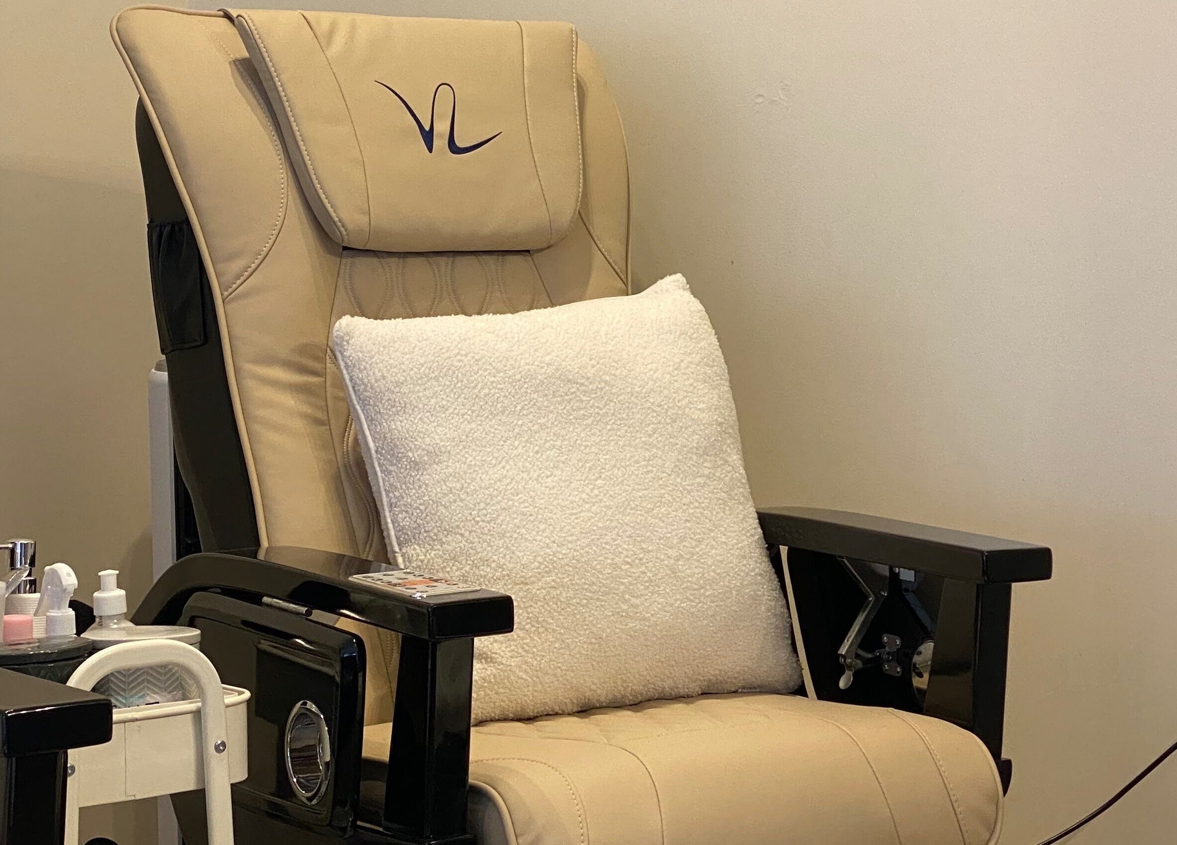 Cozy pedicure chair at Nhi's Nails, Truro, England, GB, with plush pillow and nail supplies.