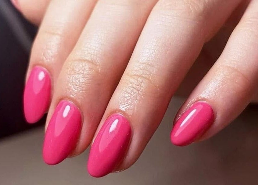 Vibrant pink manicured nails at Nhi's Nails, Truro, England, GB, showcasing expert nail artistry.