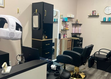 Modern styling station at Agalya Beauty Salon, Charlotte, North Carolina, US, featuring sleek chairs and product shelves.