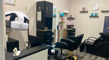 Modern styling station at Agalya Beauty Salon, Charlotte, North Carolina, US, featuring sleek chairs and product shelves.
