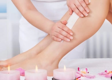 Waxing service at The Wax Club, Glasgow, Scotland. Aesthetic setting with flowers and candles.