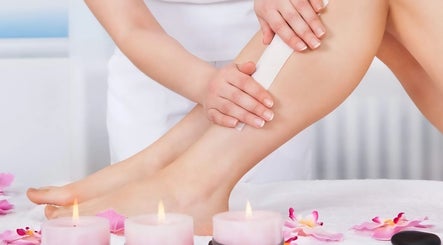 Waxing service at The Wax Club, Glasgow, Scotland. Aesthetic setting with flowers and candles.