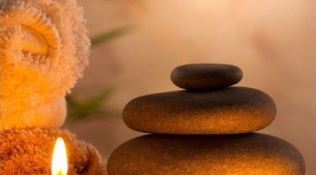 Relaxing spa stones and candle at The Wax Club, Glasgow, Scotland, GB create a calming ambiance.