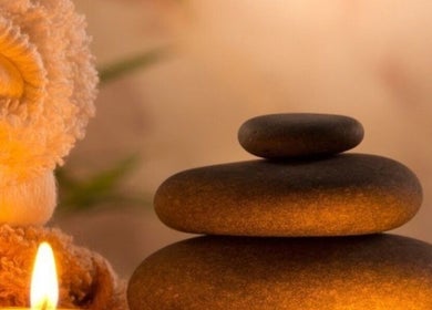 Soothing spa stones and candlelight setup at The Wax Club, Glasgow, Scotland, GB.