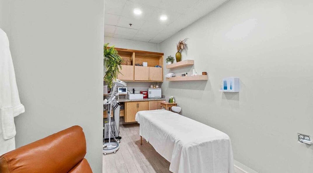 Serene treatment room at Emporio S Xpress in Mcallen, Texas, US with a massage table, plants, and modern decor.