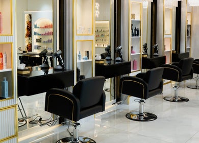 Elegant salon interior at Helin Eren Beauty Hair Spa in Dubai, Dubai, AE with chic black chairs and stylish decor.