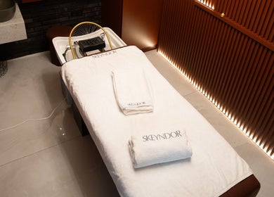 Relaxing treatment room at Helin Eren Beauty Hair Spa, Dubai, Dubai, AE, featuring a spa bed with elegant towels.
