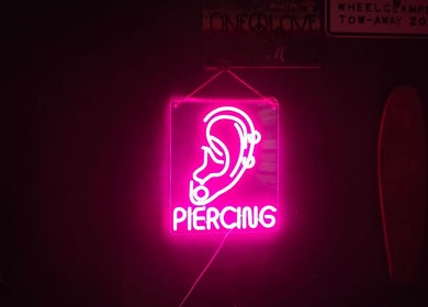 Neon ear piercing sign glowing at Needle Narratives, Cebu City, Central Visayas, PH.
