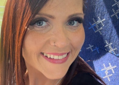 Happy woman enjoying a sunny day, showcasing services at Fabulash by Kimberley in Elgin, Scotland, GB.