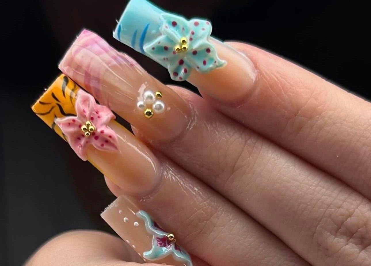 Intricate floral nail design by ABL Nails, Erie, Pennsylvania, US, featuring vibrant 3D flowers.