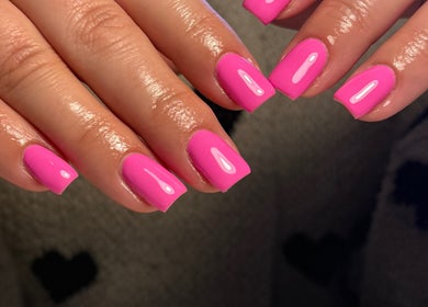 Vibrant pink manicured nails at The Beauty Studio by Charlotte, Wickham Bishops, England, GB.