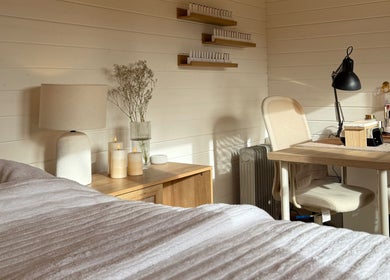 Cozy interior at The Beauty Studio by Charlotte, Wickham Bishops, England with candles and a massage bed.
