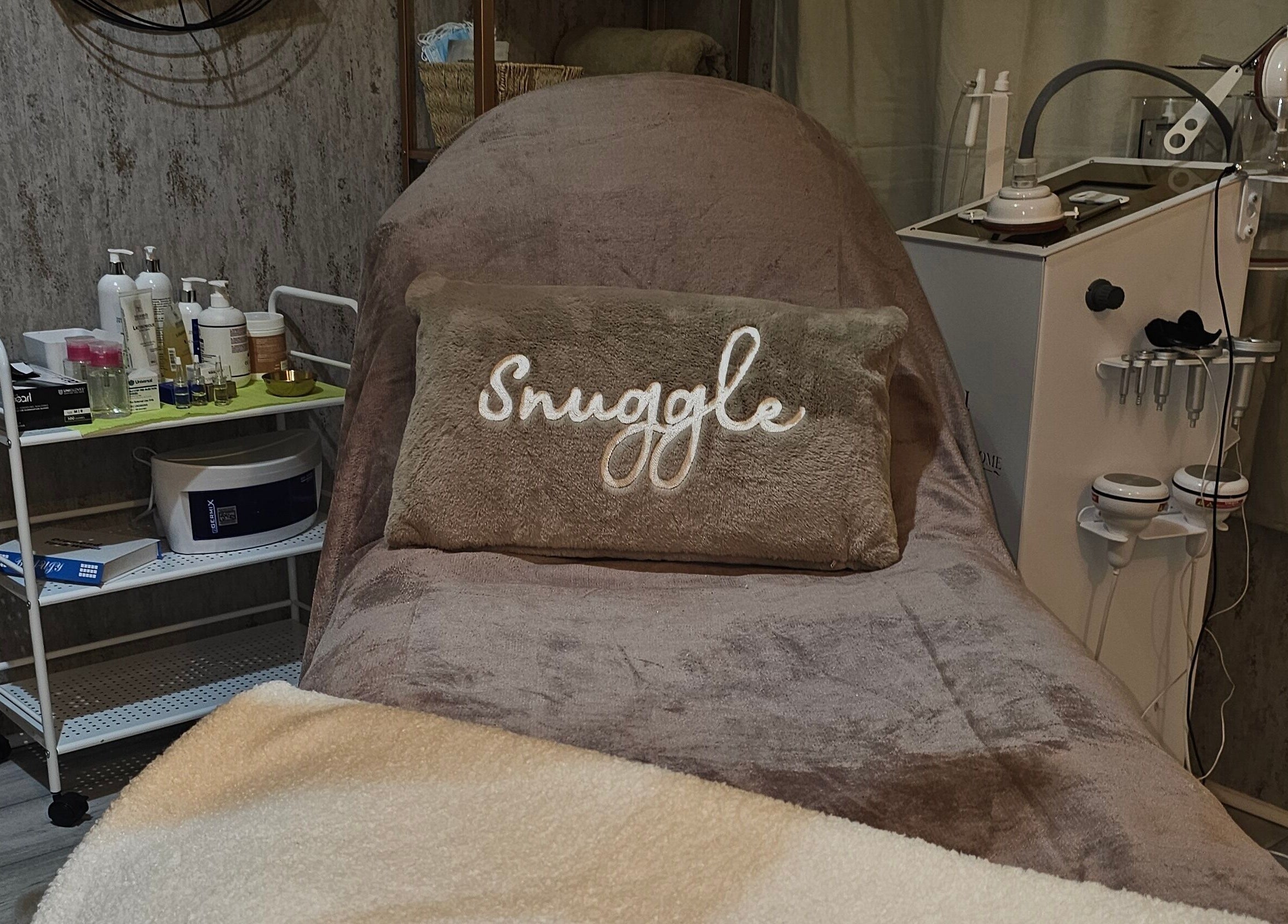 Cozy treatment area at Beauty Home, Edinburgh, Scotland, GB, featuring a plush bed and skincare equipment.