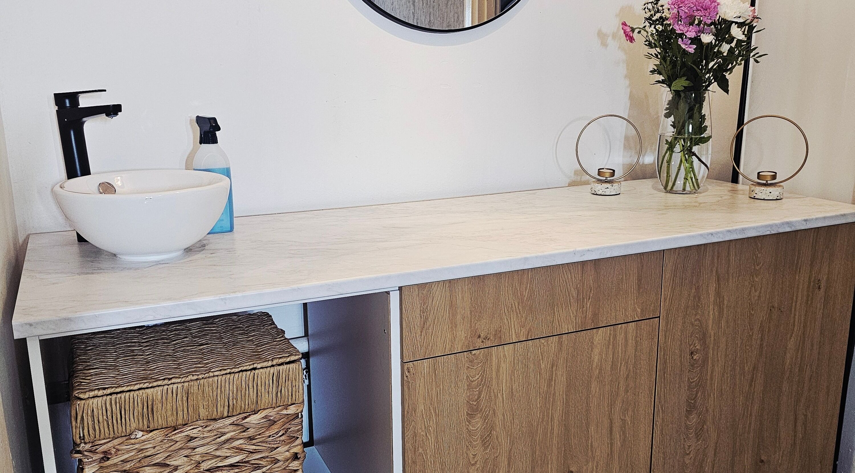Elegant vanity top at Beauty Home in Edinburgh, Scotland, GB with flowers and candle holders.