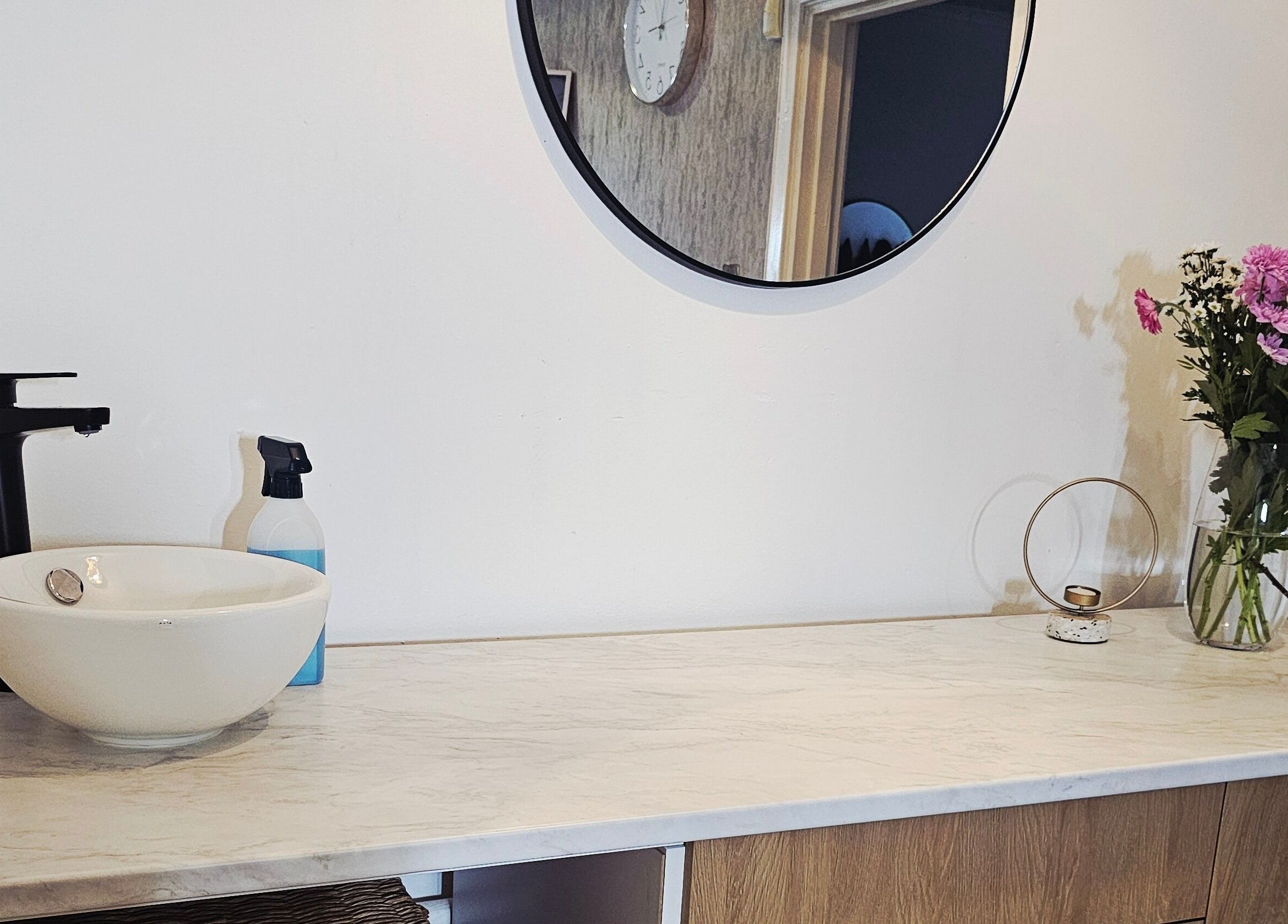 Elegant vanity with round mirror and flowers at Beauty Home in Edinburgh, Scotland, GB.