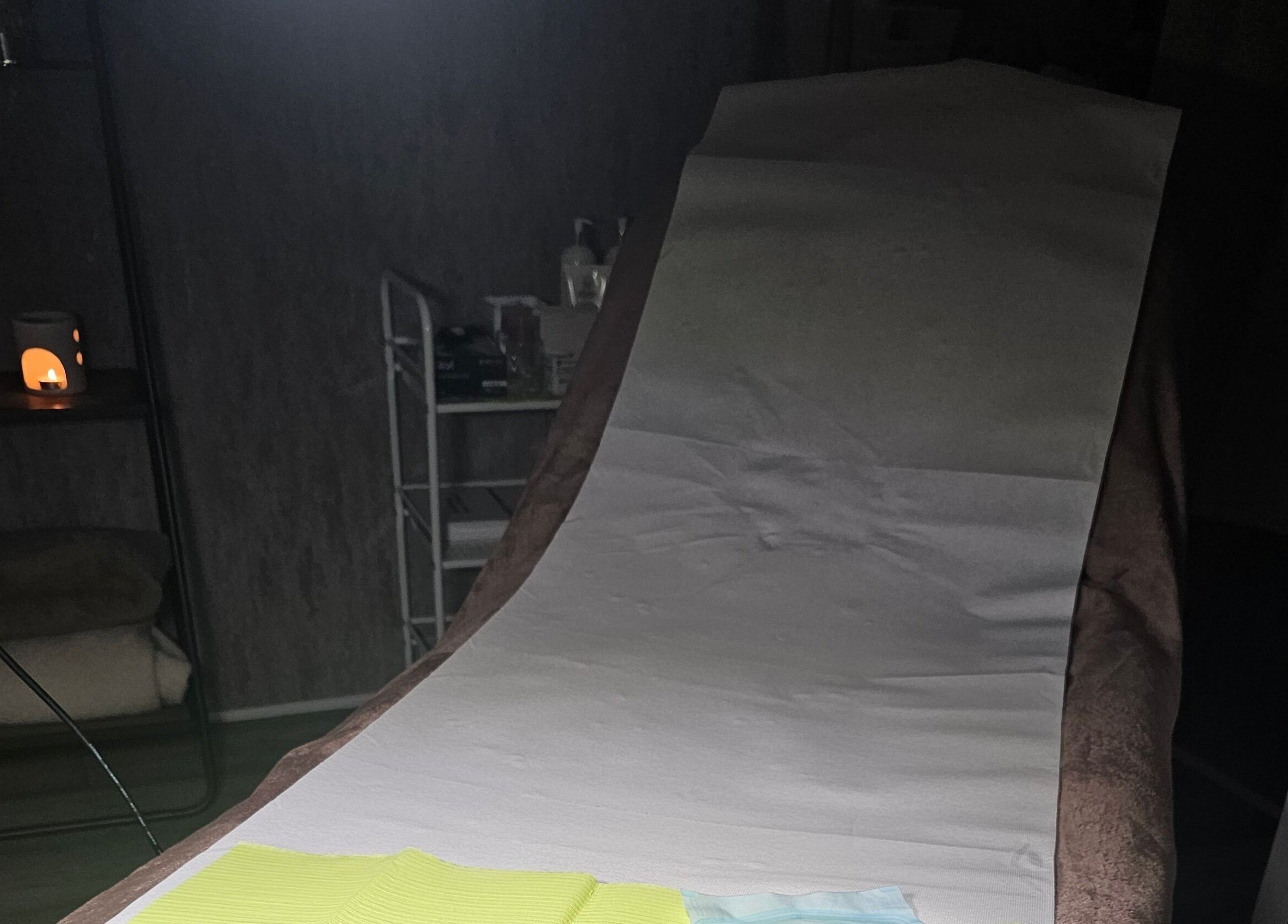 Relaxing beauty treatment room at Beauty Home, Edinburgh, Scotland, GB, featuring a cozy massage table.