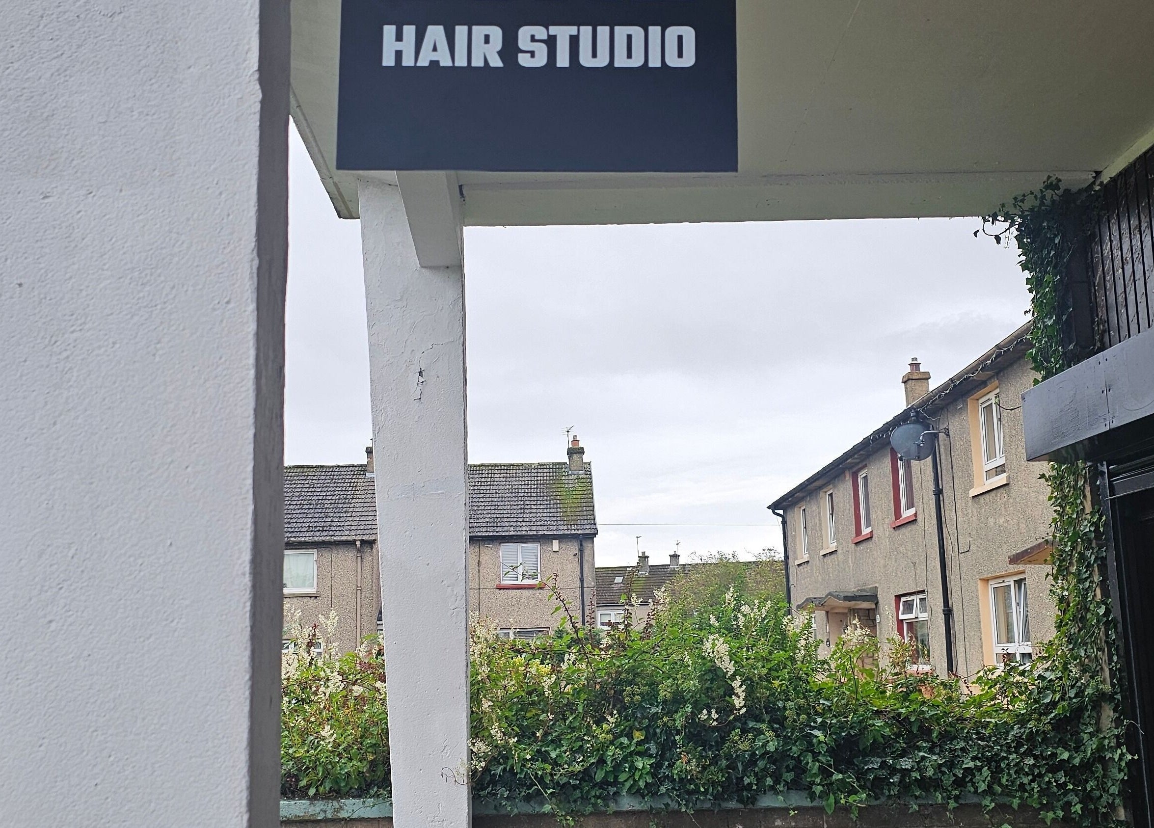 Beauty Home's Hair Studio entrance in Edinburgh, Scotland, GB with greenery and residential view.
