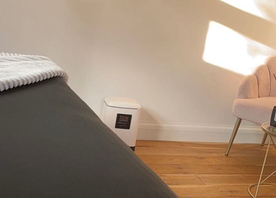 Relaxing treatment room at Arch & Lash co., Guildford, England, GB with cozy chair and table.